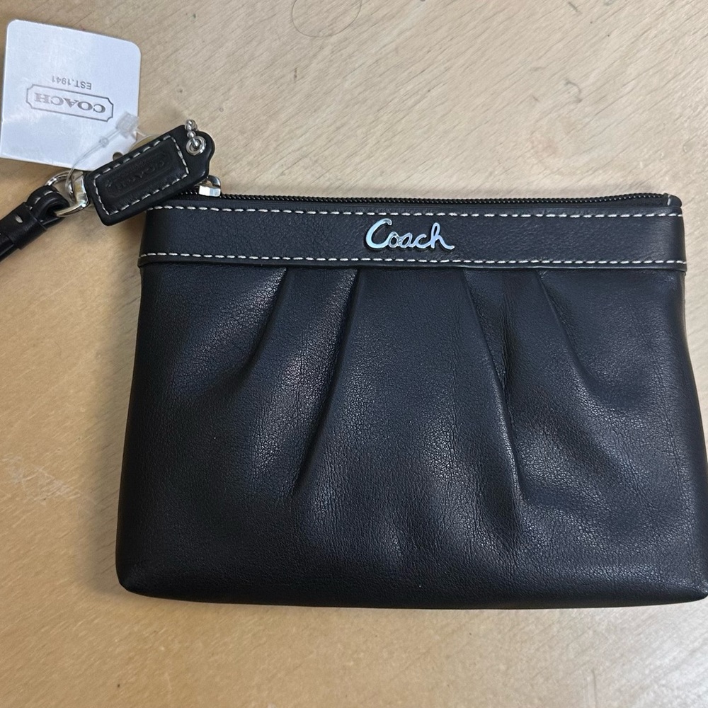 Coach Black Leather Pouch
One inside pocket